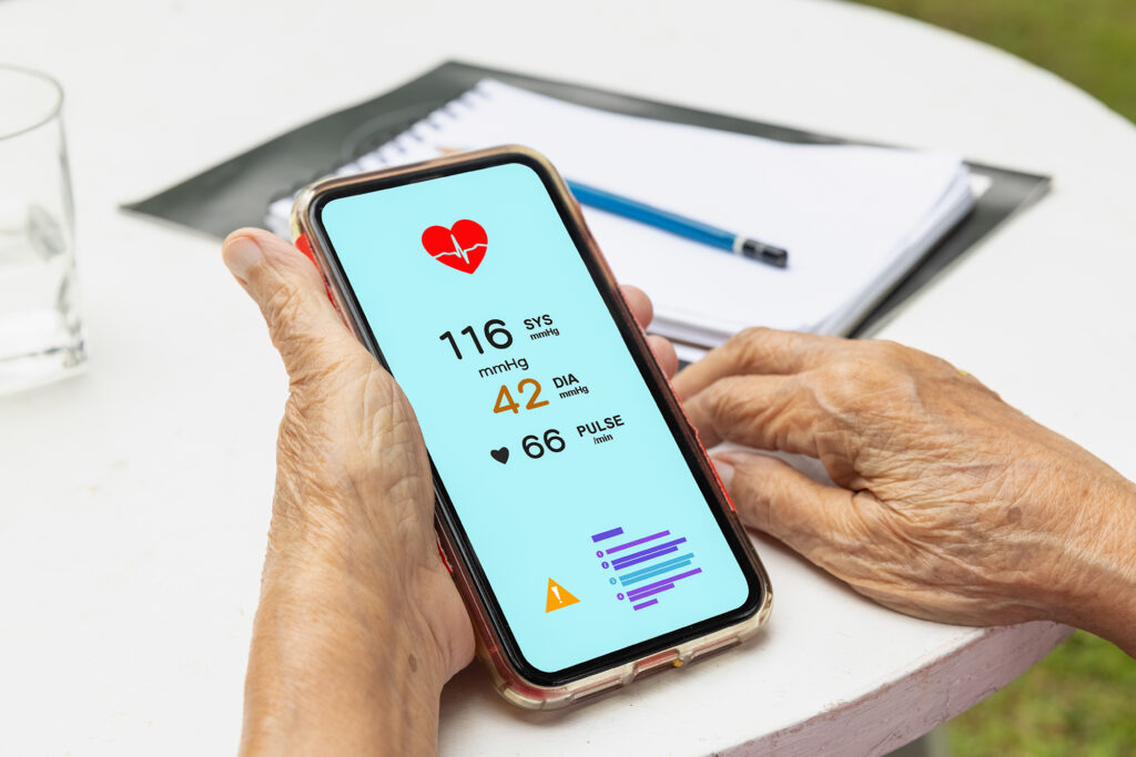 Senior woman checking blood pressure (hypertension) vai mobile p
